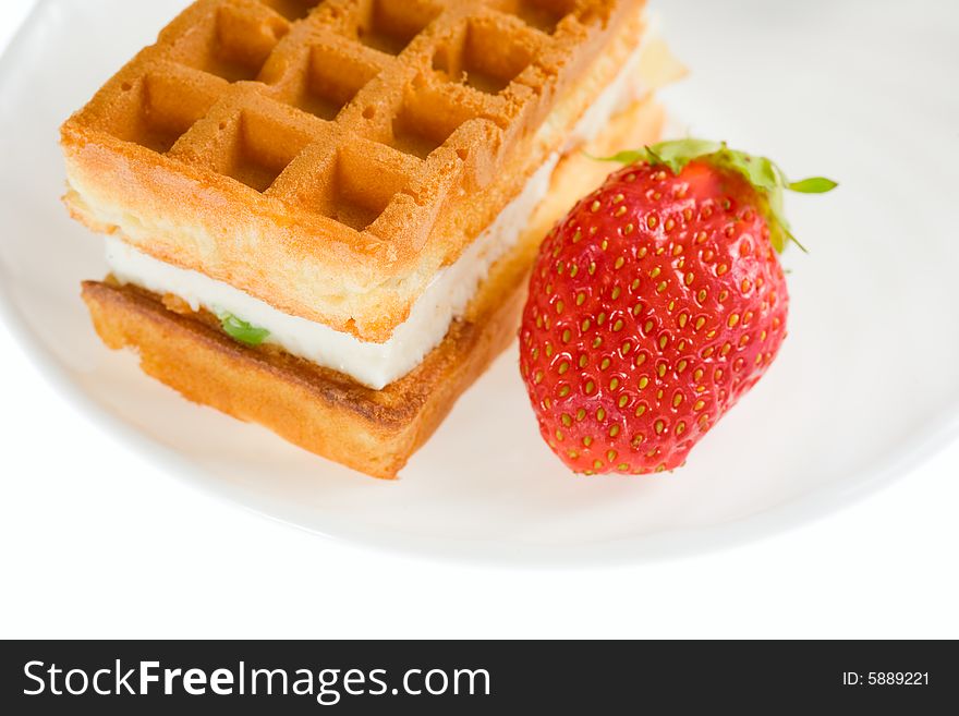 Tasty cake on a plate with a strawberry