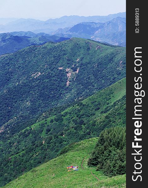 Hiking tents by the woods in the mountains. Hiking tents by the woods in the mountains