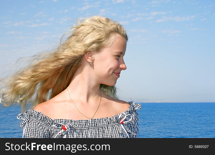 Pretty blond girl with long hair at the sea. Pretty blond girl with long hair at the sea.