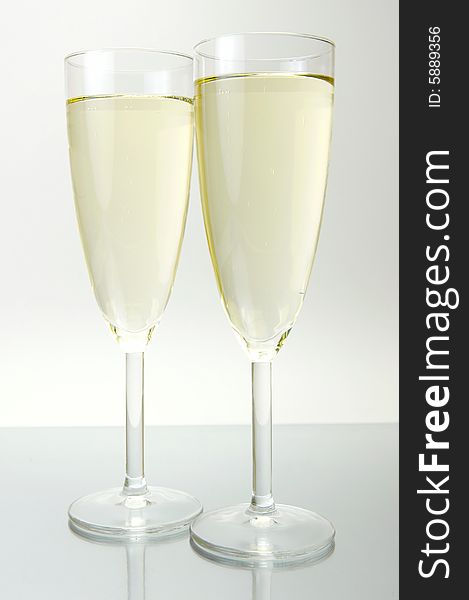 Flutes of sparkling wine isolated against a white background