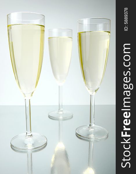 Flutes of sparkling wine isolated against a white background