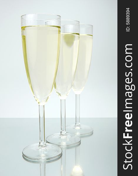 Flutes of sparkling wine isolated against a white background