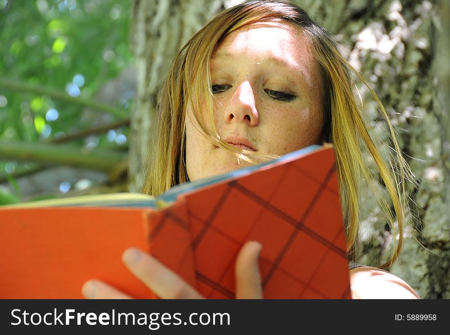 A woman in the park reading a book
