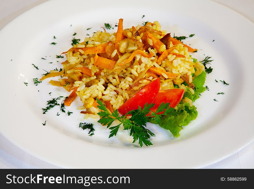 Fresh tasty salad of rice and vegetables on a plate closeup