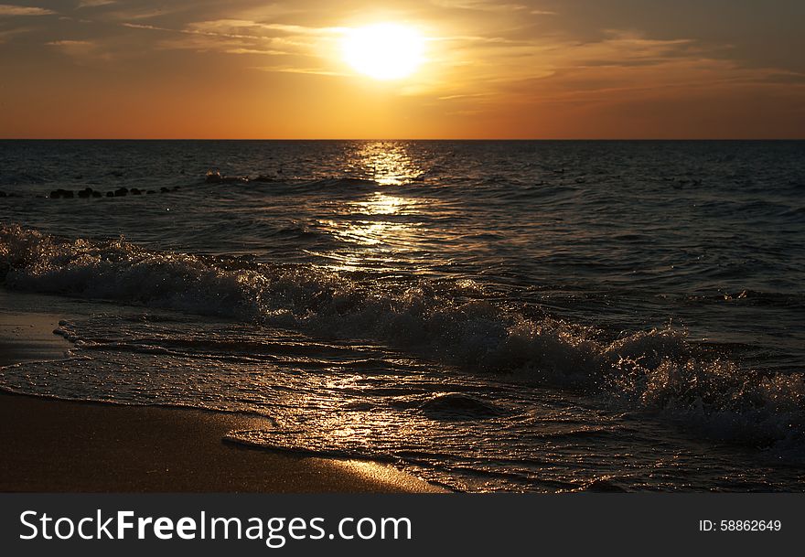 Bright yellow sunset at the sea on autumn