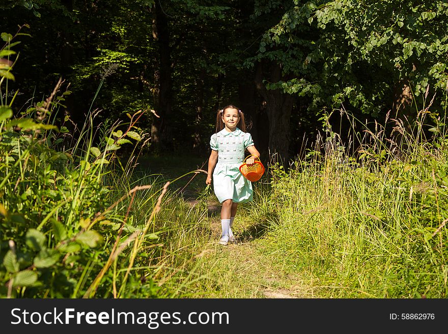 Little girl in green dress goes out of the forest. Little girl in green dress goes out of the forest