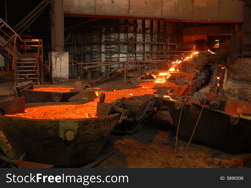 Glowing, molten hot steel. Stell casting. Glowing, molten hot steel. Stell casting.