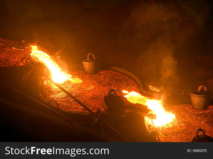 Glowing, molten hot steel. Stell casting. Glowing, molten hot steel. Stell casting.