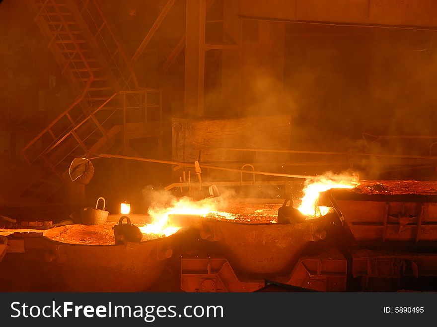 Glowing, molten hot steel. Stell casting. Glowing, molten hot steel. Stell casting.