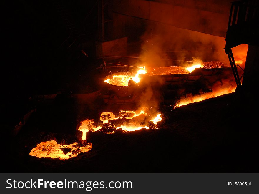 Glowing, molten hot steel. Stell casting. Glowing, molten hot steel. Stell casting.