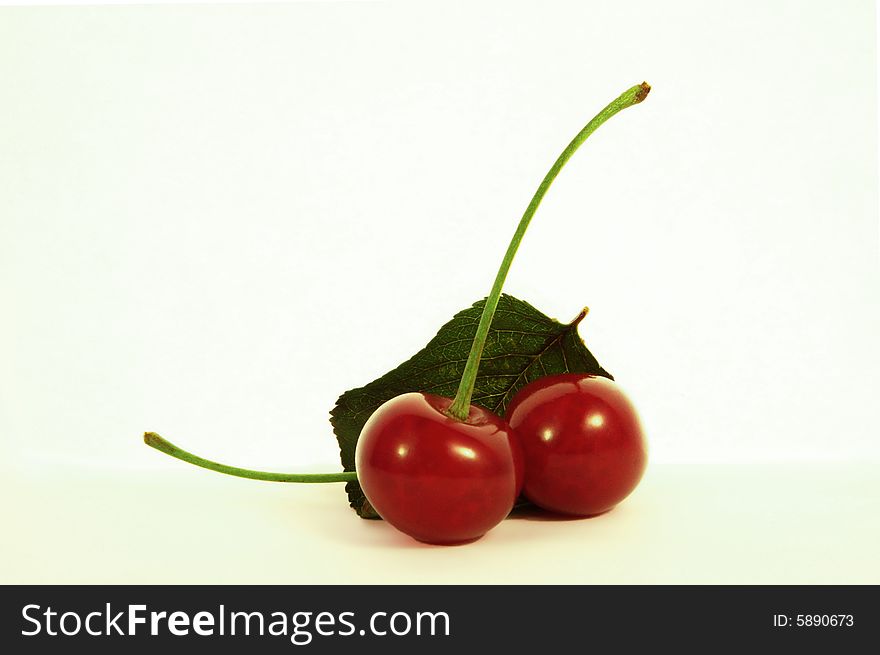Two soft cherries with cherry leaf. Two soft cherries with cherry leaf