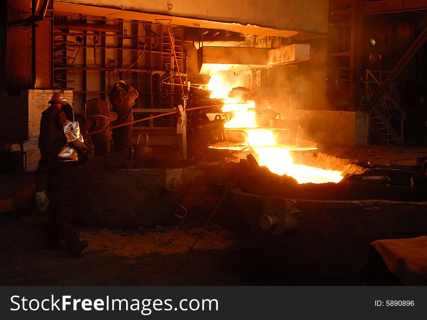 Glowing, molten hot steel. Stell casting. Glowing, molten hot steel. Stell casting.