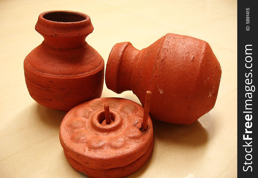 A couple of miniature pots n grinder made of mud. A couple of miniature pots n grinder made of mud