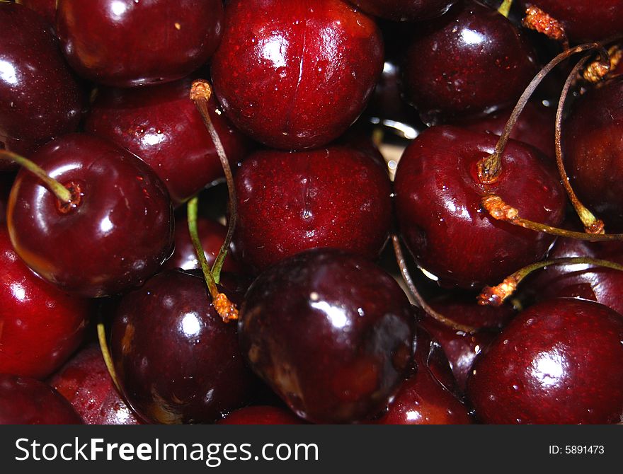 A lot of a juicy bright red brilliant sweet cherry. A lot of a juicy bright red brilliant sweet cherry