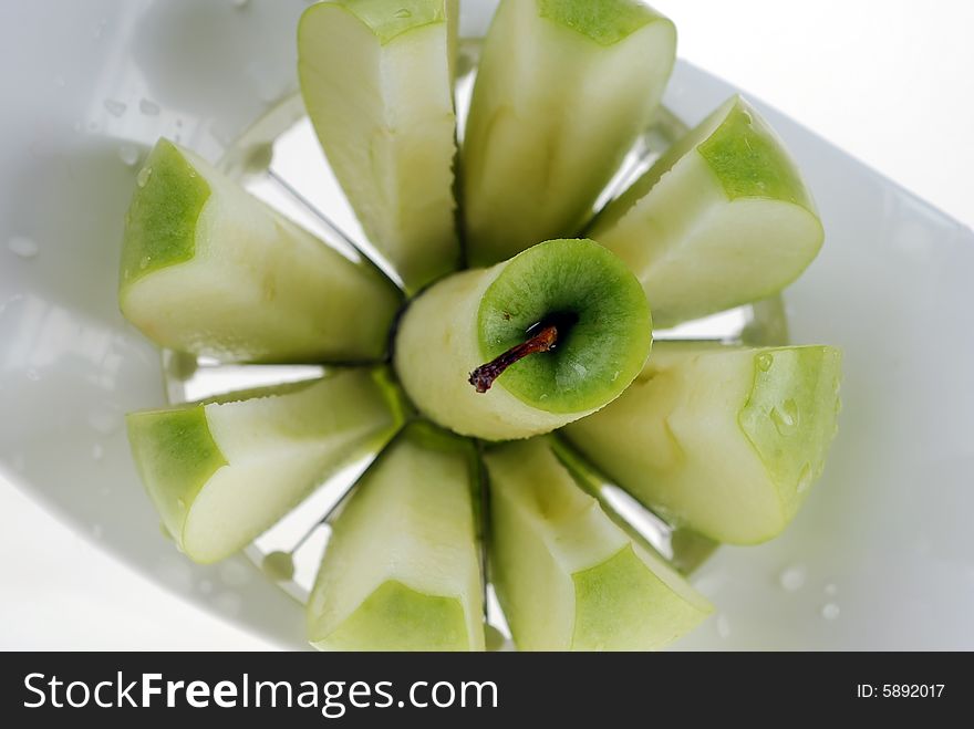 Delicious fresh green Apple slices on cutting board before serving