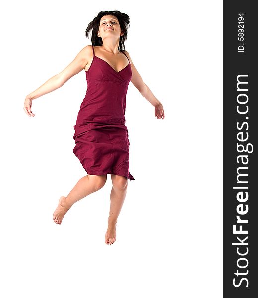 Beautiful young lady in red sun-dress jumping isolated white. Beautiful young lady in red sun-dress jumping isolated white