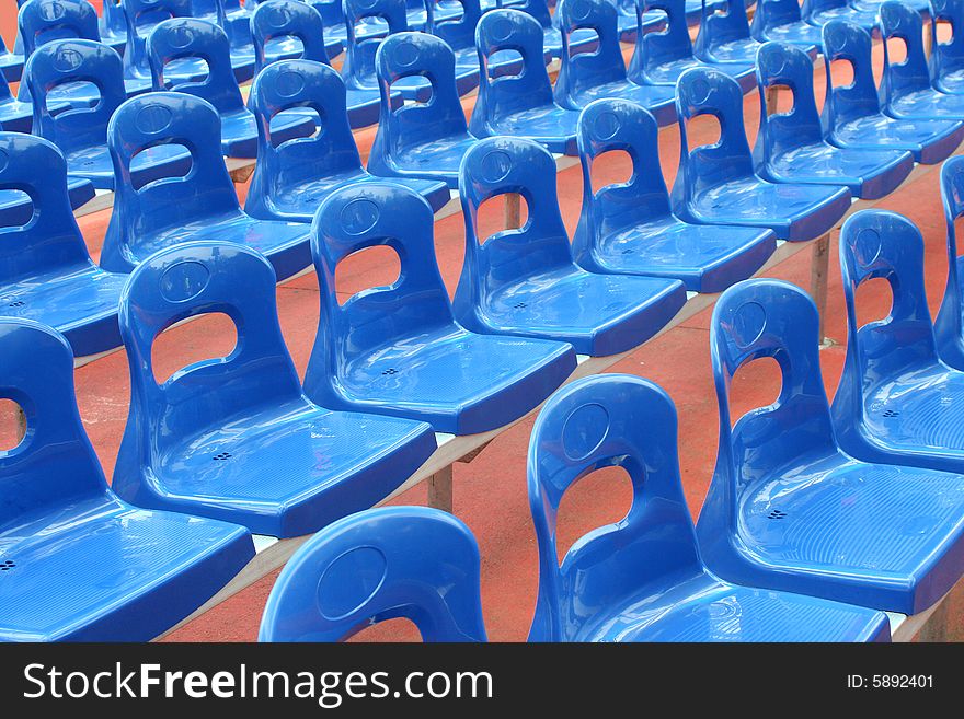 Rows of blue stadium seats