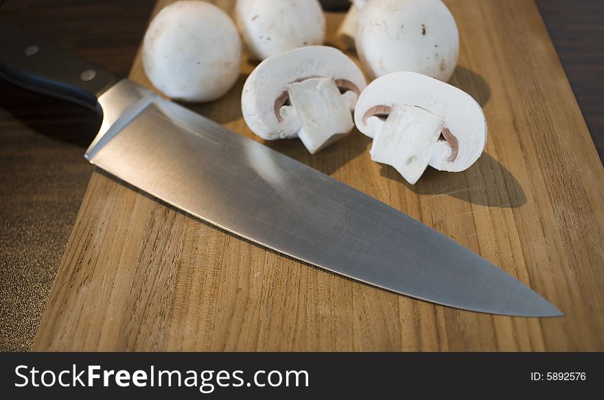 Some fresh mushrooms on a wooden board