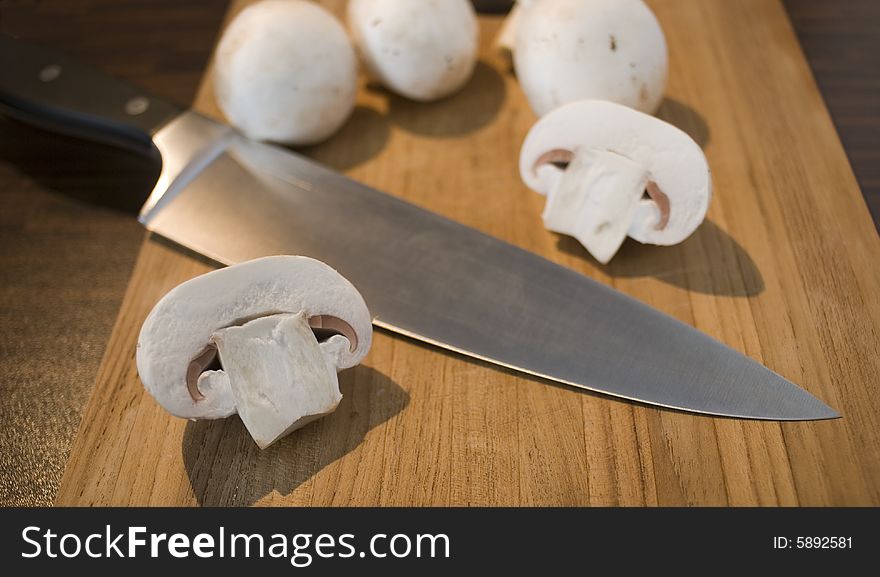 Some fresh mushrooms on a wooden board