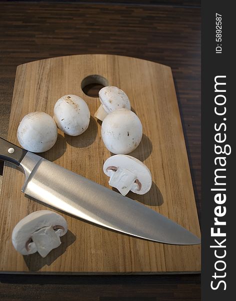 Some fresh mushrooms on a wooden board