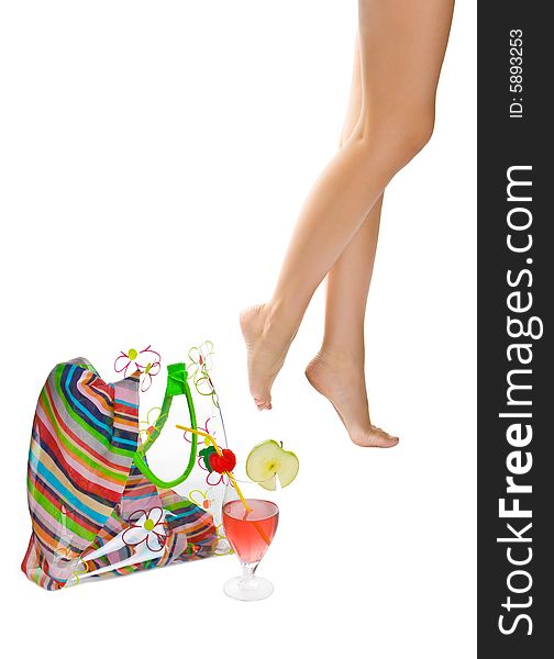 Female legs, beach bag, solar glasses and cocktail isolated on a white background. Female legs, beach bag, solar glasses and cocktail isolated on a white background