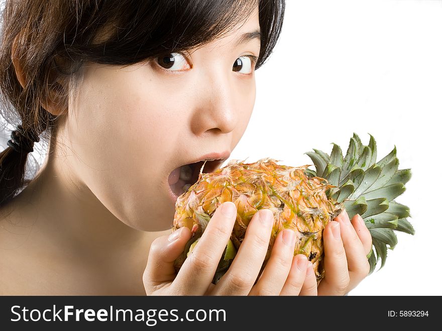 Young asian female holding a ripe and fresh pineapple. isolated picture shot in studio. Young asian female holding a ripe and fresh pineapple. isolated picture shot in studio