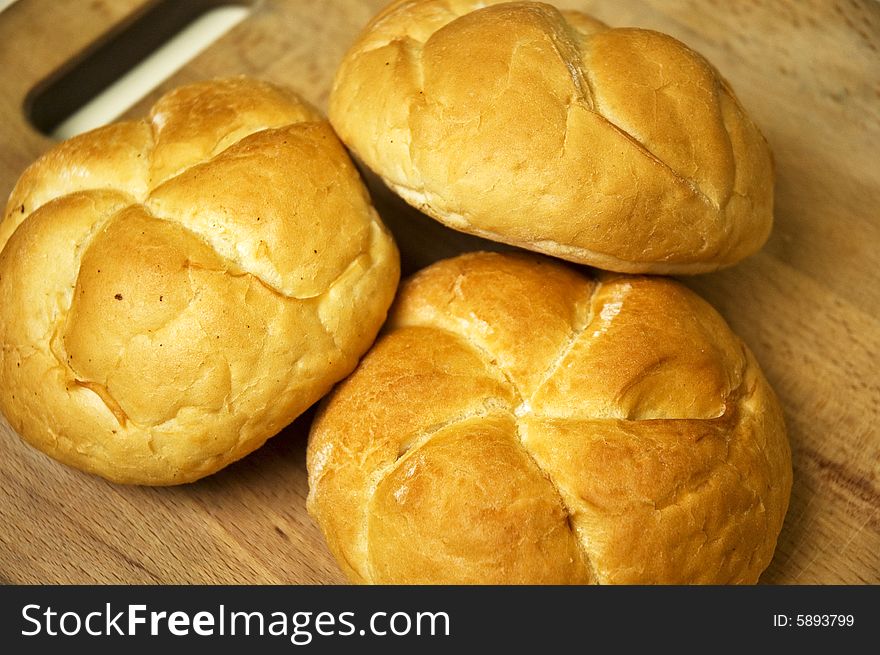 Bread roll on kitchen board.