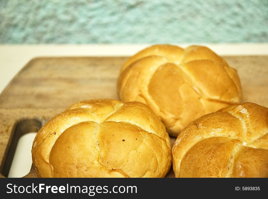 Bread roll on kitchen board.