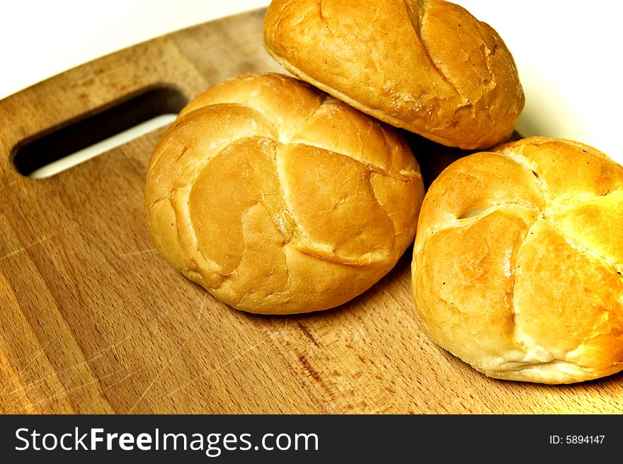 Bread roll on kitchen board.