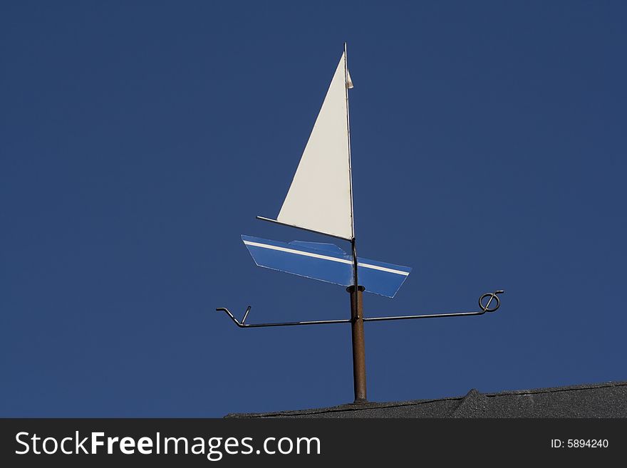 Weather vane - Blue boat - against the blue sky