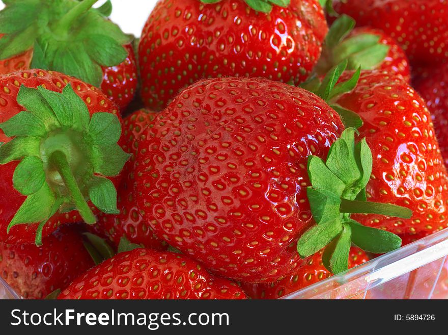 Fresh, ripe strawberry in a transparent tray