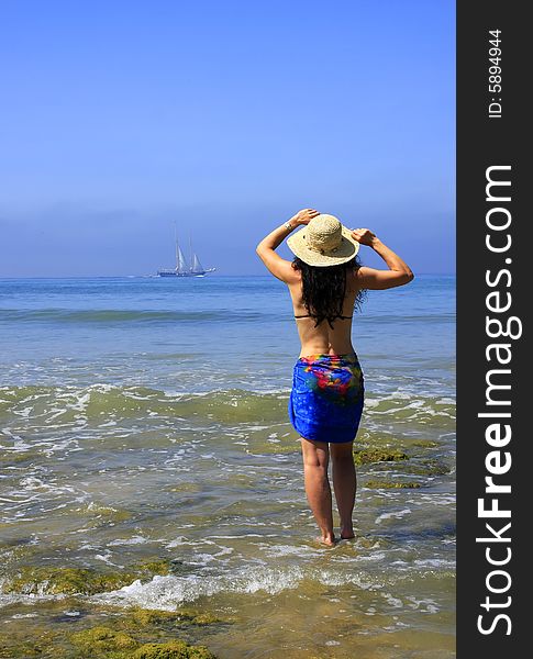 Woman standing at the beach at low tide. Woman standing at the beach at low tide.