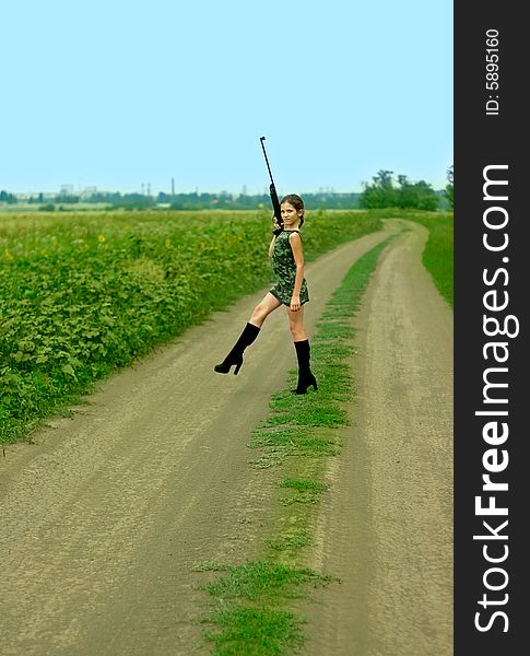 Girl with gun on road for your design