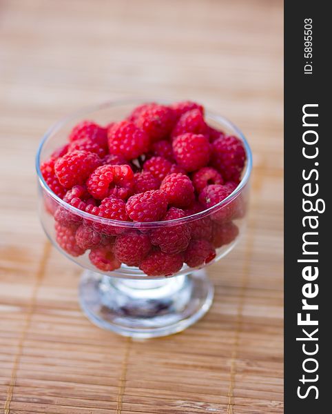 Raspberry in a transparent cup