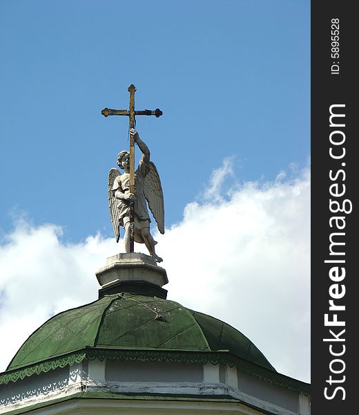 Angel with a cross on a dome house church in the name of the Origin of fair trees of Life-giving Cross gospodnja - Vsemilostivogo Spasa in ancient manor Sheremetev Kuskovo's column in Moscow. Angel with a cross on a dome house church in the name of the Origin of fair trees of Life-giving Cross gospodnja - Vsemilostivogo Spasa in ancient manor Sheremetev Kuskovo's column in Moscow