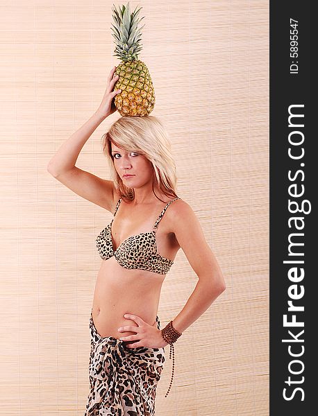 Tropical girl with the pineapple on the head