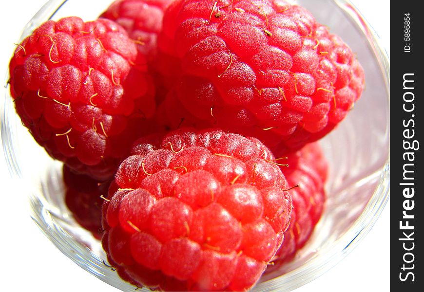 Several raspberries in the glass. Several raspberries in the glass