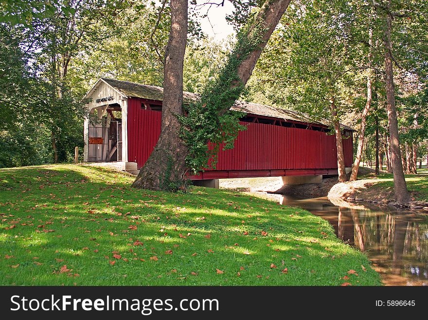 Covered bridge in a park in summer. Covered bridge in a park in summer