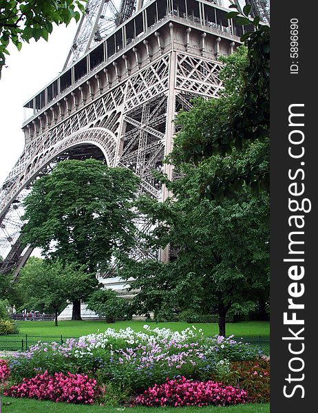 Foot of the Eiffel Tower with flowers in bloom. Foot of the Eiffel Tower with flowers in bloom