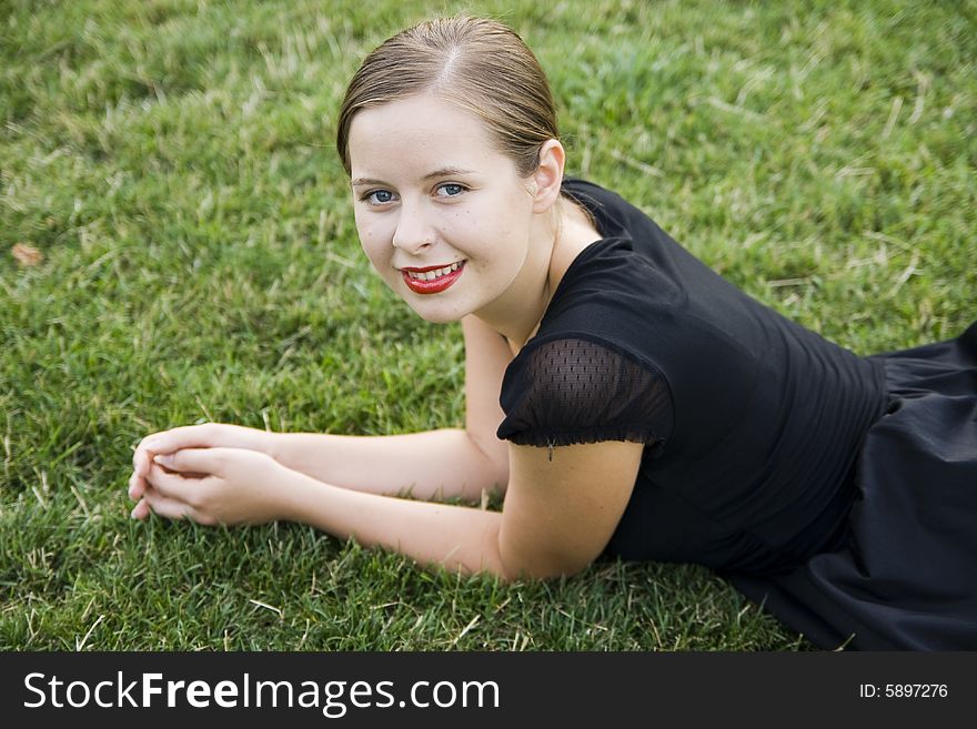 Young pretty smiling girl on lawn