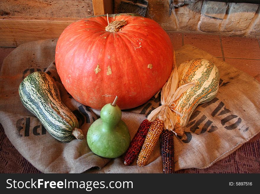 Pumpkin gourds squash corn on a burlap sack. Pumpkin gourds squash corn on a burlap sack