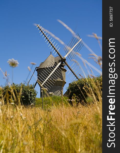 Windmill in wide field in brittany in france