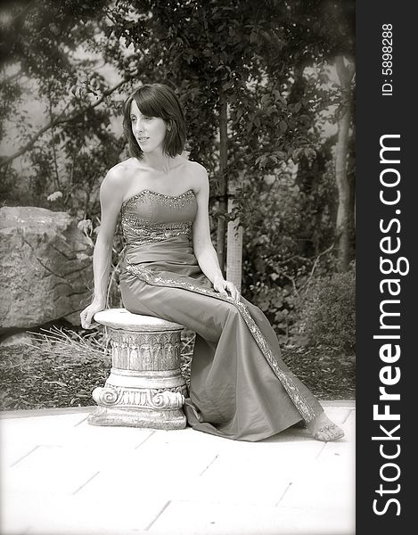 Glamor model posing on an old, antique stool. Glamor model posing on an old, antique stool.