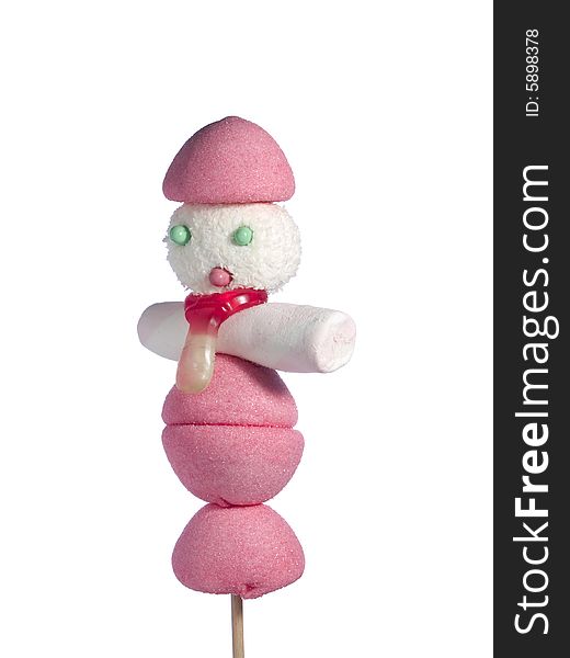 A male figurine made out of candies on a stick over a white background. A male figurine made out of candies on a stick over a white background.