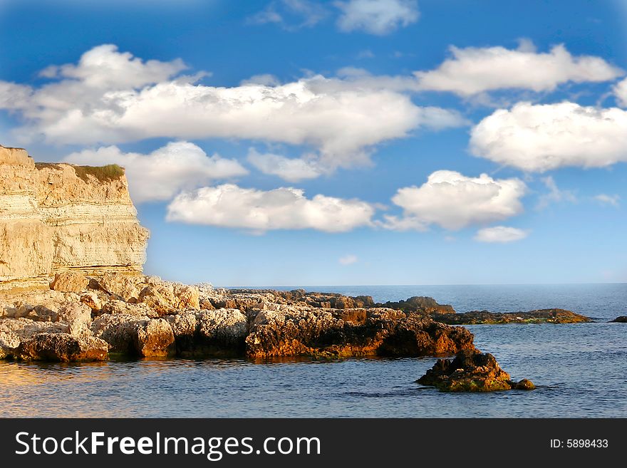 Seascape with rocks and clouds