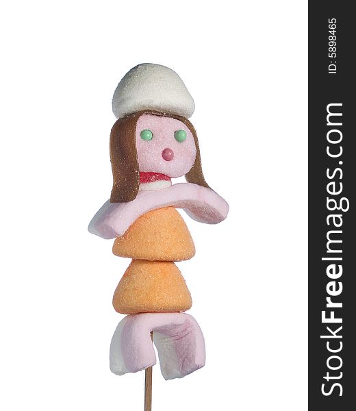 A female figurine made out of candies on a stick over a white background. A female figurine made out of candies on a stick over a white background.