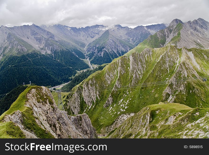 Dramatic weather change. Scenic view of storm clouds over Swiss Alps mountains near Samnaun, Graubunden Canton, Switzerland. Dramatic weather change. Scenic view of storm clouds over Swiss Alps mountains near Samnaun, Graubunden Canton, Switzerland.