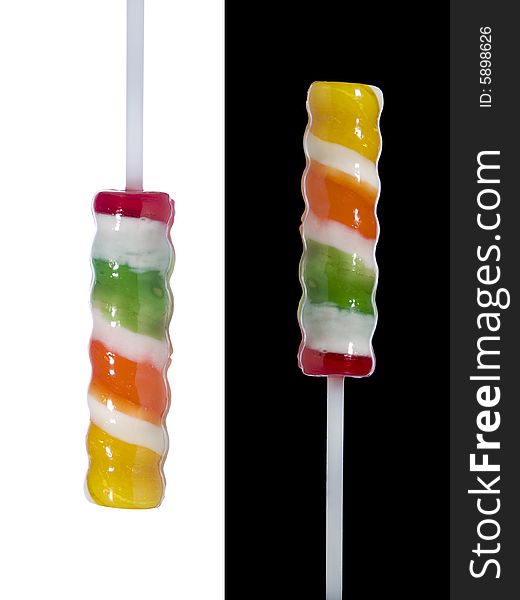 Two lollipop sticks pointing in opposite directions over black and white backgrounds respectively