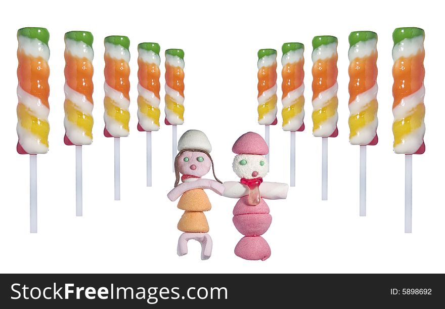A couple of candy people in the middle of several lollipop sticks in a perspective disposition over white background. A couple of candy people in the middle of several lollipop sticks in a perspective disposition over white background.
