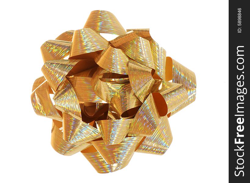 A macro image of a shiny gold bow.
